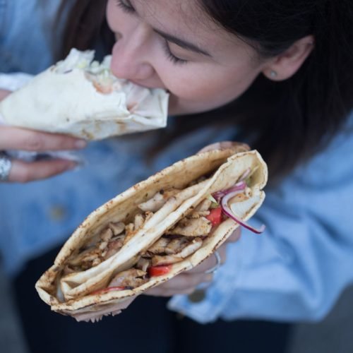 a-young-woman-holding-fast-food-close-up-2025-03-16-16-43-45-utc